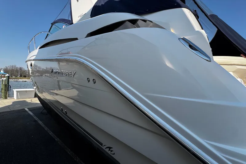Slide: The Image of 2007 Monterey 330 Sport Yacht docked, showcasing sleek white exterior design. - 3