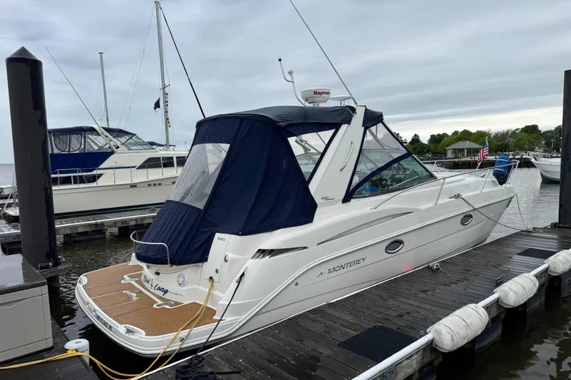 Slide: The Image of 2007 Monterey 330 Sport Yacht docked at marina, featuring sleek design and blue canopy. - 41