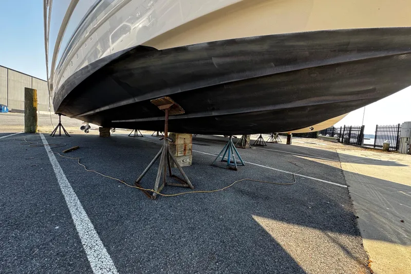 Slide: The Image of 2007 Monterey 330 Sport Yacht on stands in a marina parking lot. - 6