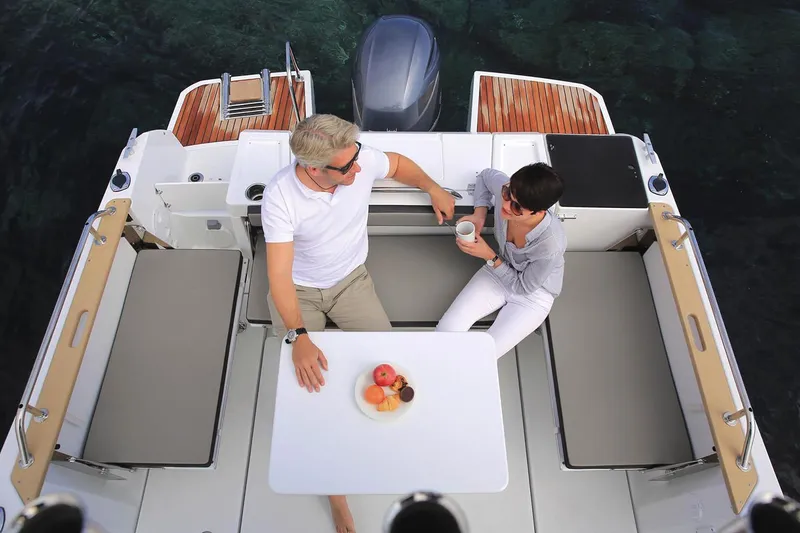 Slide: The Image of Manufacturer Provided Image: Couple enjoying breakfast on 2018 Jeanneau NC Sport 795 boat. - 10