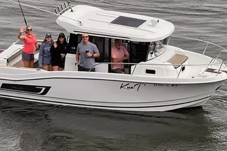 Slide: The Image of 2018 Jeanneau NC Sport 795 boat with people onboard, cruising on water. - 2