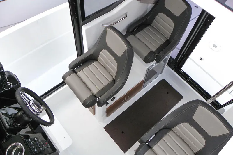 Slide: The Image of Manufacturer Provided Image: 2018 Jeanneau NC Sport 795 interior cockpit with three seats and steering wheel. - 8