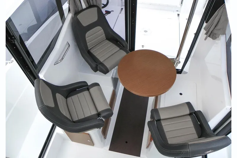 Slide: The Image of Manufacturer Provided Image: 2018 Jeanneau NC Sport 795 interior seating area with round table and three chairs. - 9