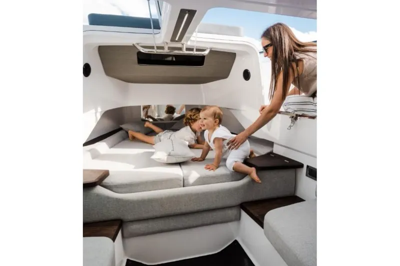 Slide: The Image of Family enjoying the interior of a 2027 Axopar 37 Sun-Top boat. - 10