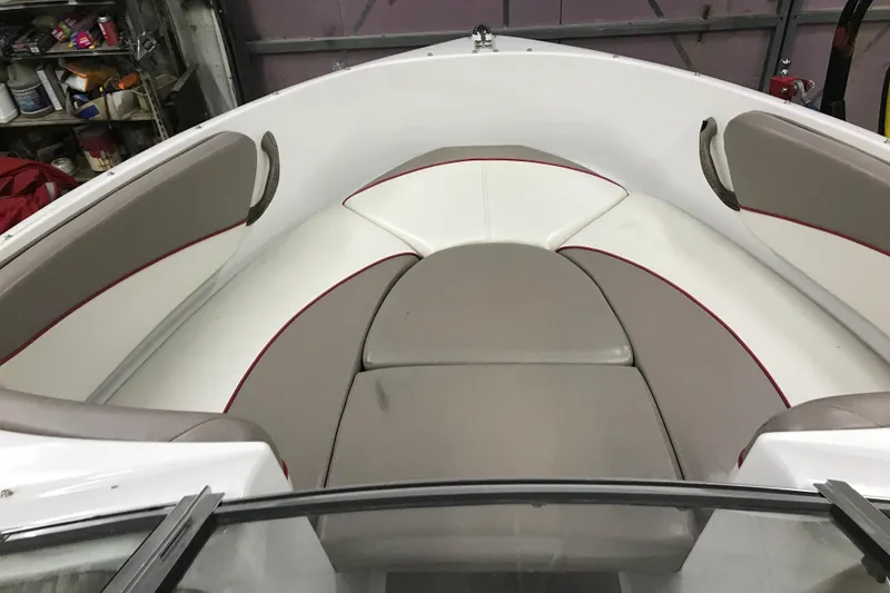 Slide: The Image of 2002 Four Winns 180 Horizon boat interior with beige and white seating. - 12