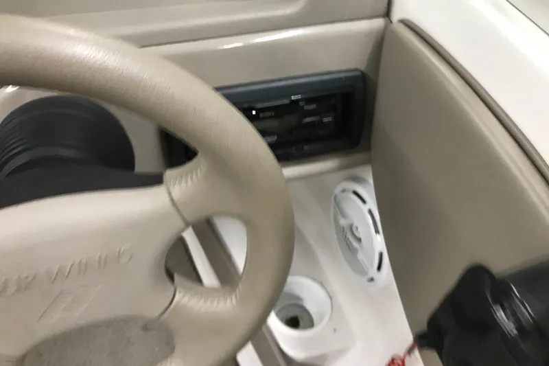 Slide: The Image of Steering wheel and dashboard of 2002 Four Winns 180 Horizon boat interior. - 14