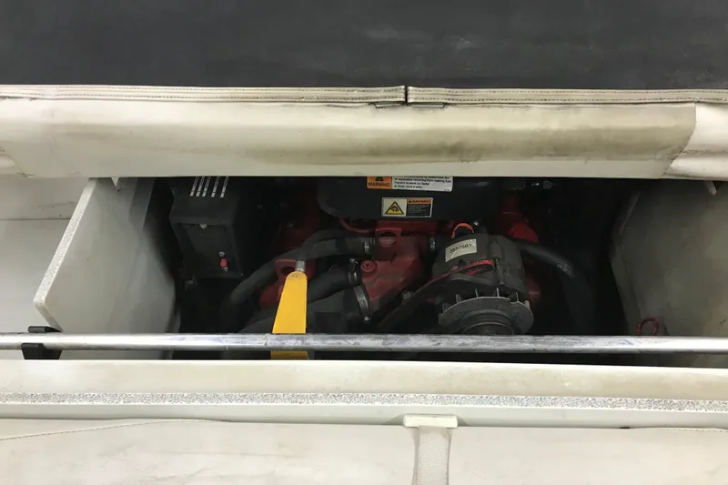 Slide: The Image of Engine compartment of a 2002 Four Winns 180 Horizon boat, showcasing mechanical components. - 18