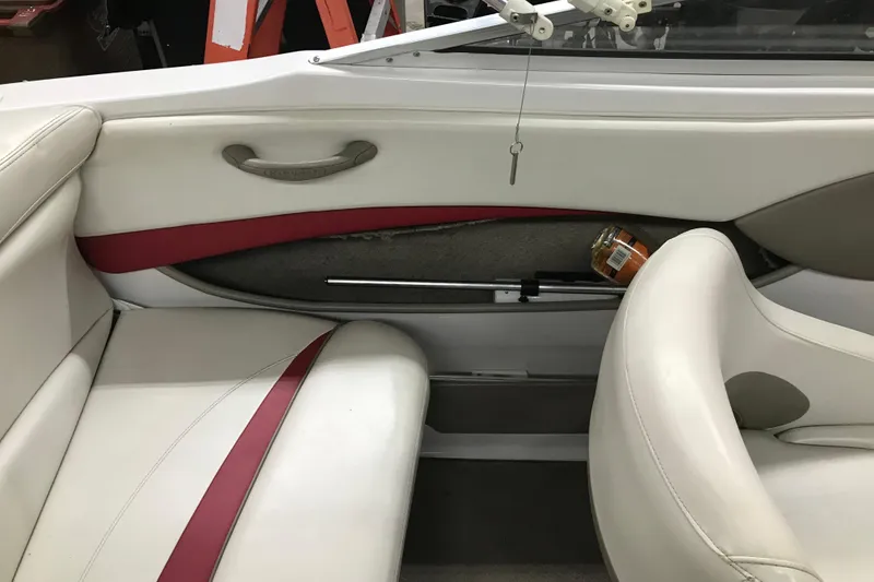 Slide: The Image of Interior of a 2002 Four Winns 180 Horizon boat with white and red seating. - 21