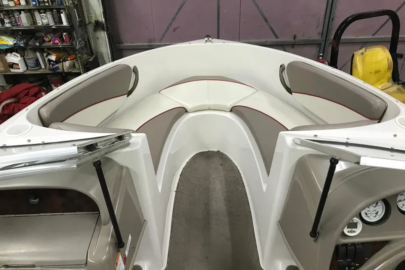 Slide: The Image of Interior view of a 2002 Four Winns 180 Horizon boat with cushioned seating. - 23