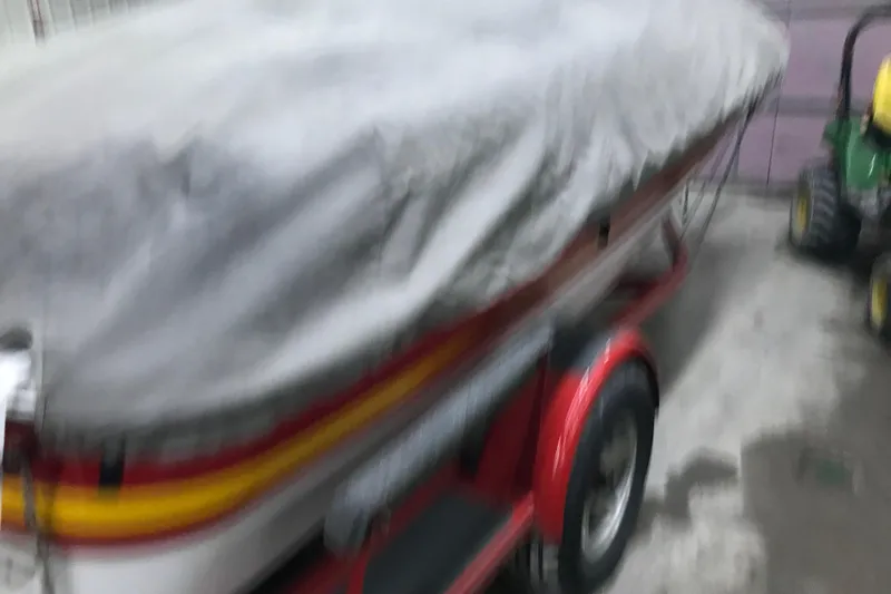 Slide: The Image of Covered 2002 Four Winns 180 Horizon boat on trailer in garage. - 27