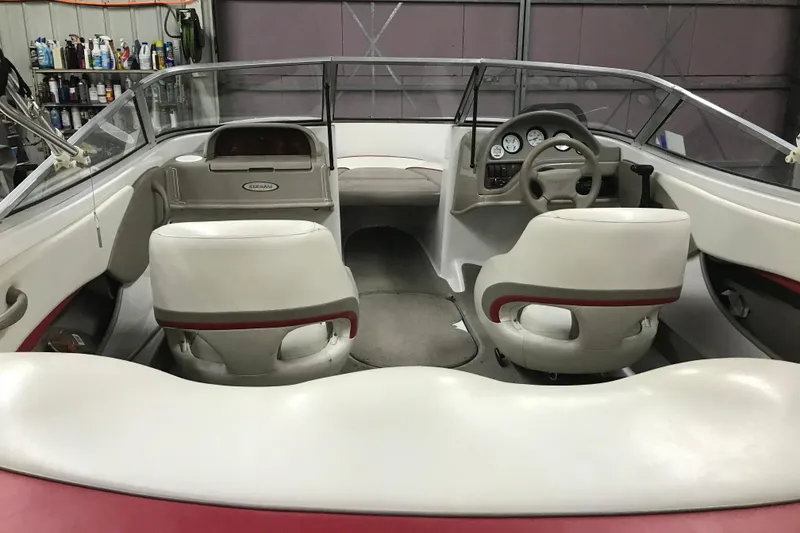 Slide: The Image of Interior of a 2002 Four Winns 180 Horizon boat with white seating and dashboard. - 6