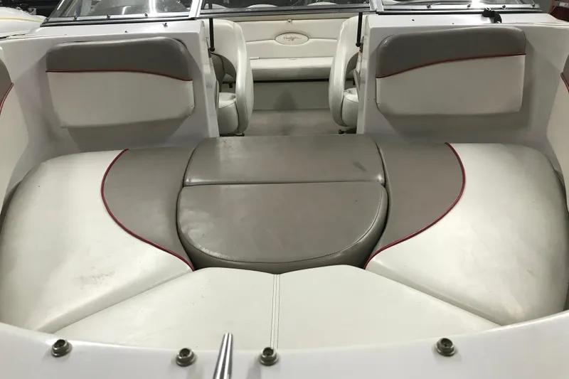 Slide: The Image of Interior seating of a 2002 Four Winns 180 Horizon boat, featuring white and gray upholstery. - 7