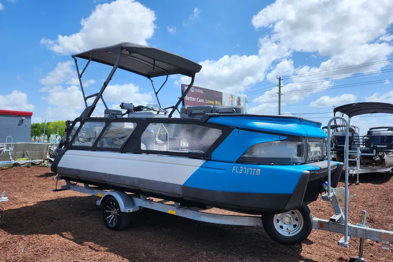 The Image of 2023 Sea-Doo Switch Cruise 21 on trailer under blue sky. - 1