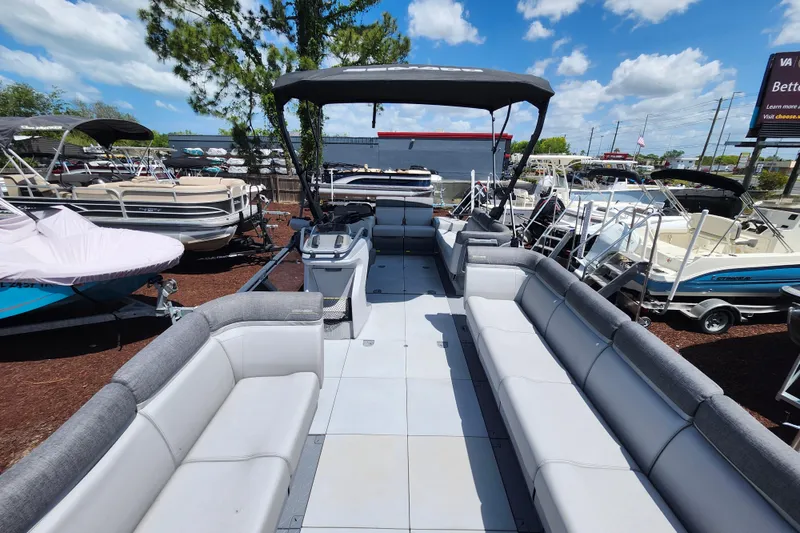 Slide: The Image of 2023 Sea-Doo Switch Cruise 21 pontoon boat with spacious seating and canopy, displayed outdoors. - 10