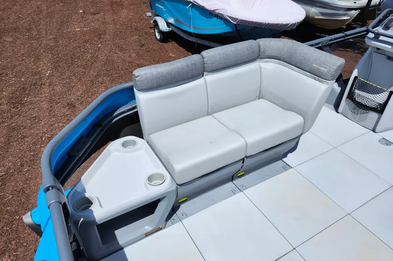 Slide: The Image of 2023 Sea-Doo Switch Cruise 21 interior with cushioned seating and cup holders. - 12