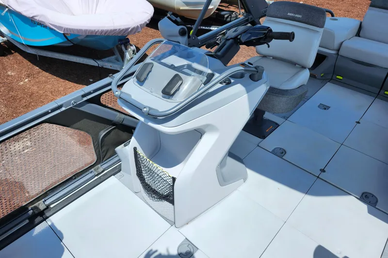 Slide: The Image of 2023 Sea-Doo Switch Cruise 21 helm with steering controls and seating. - 14