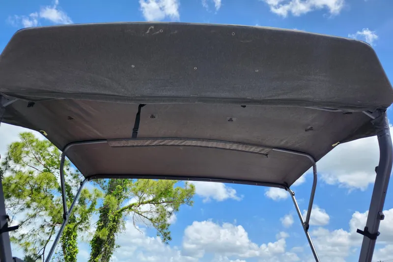 Slide: The Image of 2023 Sea-Doo Switch Cruise 21 canopy against blue sky and clouds. - 16