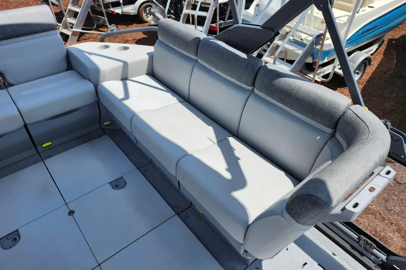 Slide: The Image of 2023 Sea-Doo Switch Cruise 21 interior with gray seating and cup holders. - 18