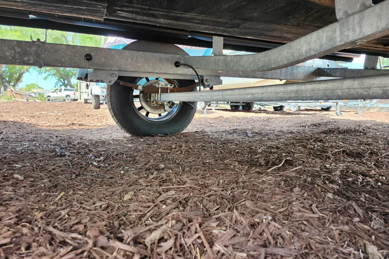 Slide: The Image of Underneath view of a 2023 Sea-Doo Switch Cruise 21 trailer on mulch ground. - 5