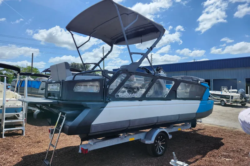 Slide: The Image of 2023 Sea-Doo Switch Cruise 21 pontoon boat on trailer under blue sky. - 8