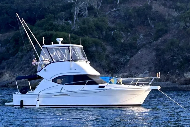 The Image of 2005 Riviera 33 Open Flybridge yacht on calm waters. - 1