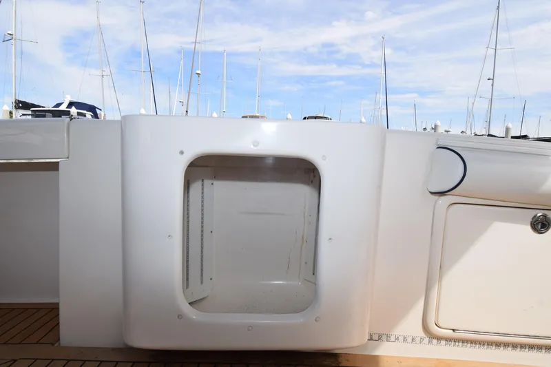 Slide: The Image of 2005 Riviera 33 Open Flybridge boat interior with storage compartment, docked at marina. - 23