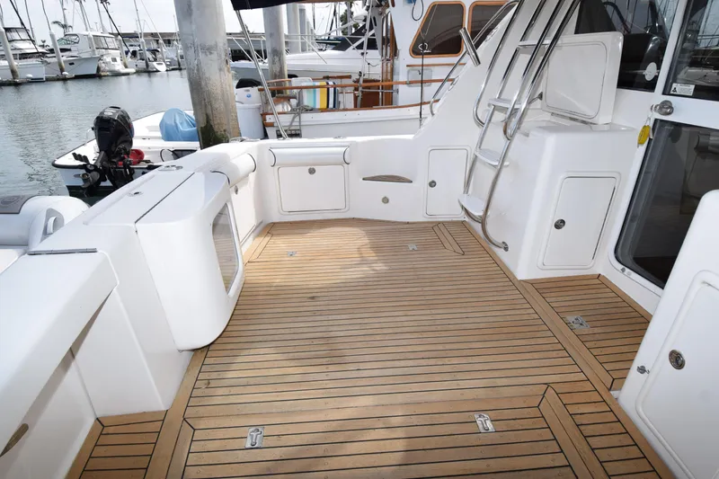 Slide: The Image of 2005 Riviera 33 Open Flybridge yacht with spacious teak deck and marina view. - 24