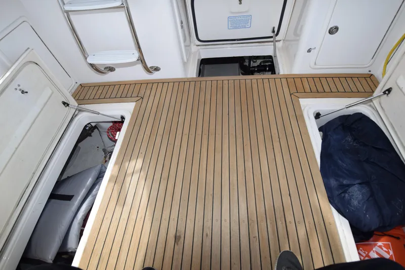 Slide: The Image of Riviera 33 Open Flybridge 2005, teak deck with storage compartments. - 26