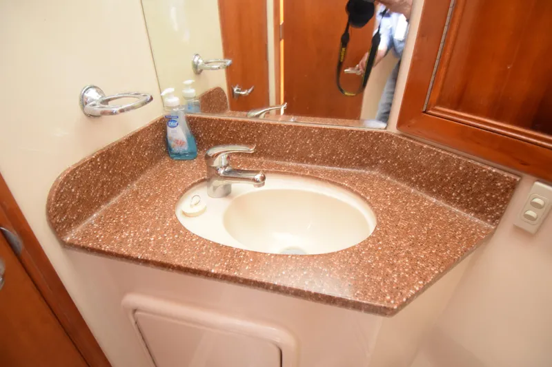 Slide: The Image of Bathroom sink with brown countertop in 2005 Riviera 33 Open Flybridge yacht. - 30