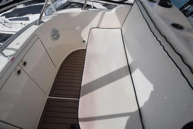 Slide: The Image of 2005 Riviera 33 Open Flybridge interior with cushioned seating and wood flooring. - 38
