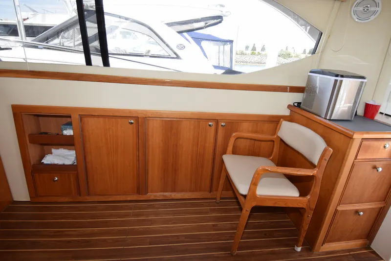 Slide: The Image of Interior of 2005 Riviera 33 Open Flybridge with wooden cabinetry and seating. - 7