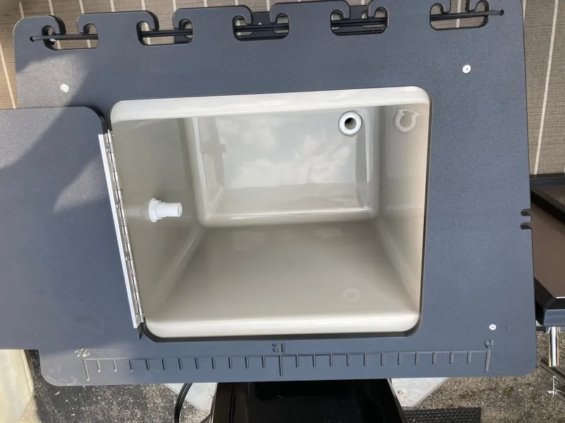 Slide: The Image of Viaggio Lago 22R 2023 storage compartment with drain opening. - 10