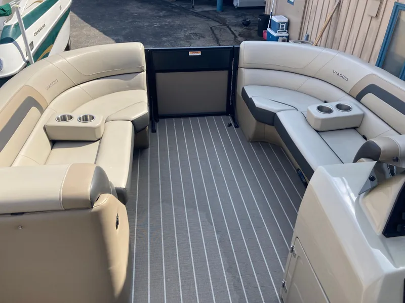 Slide: The Image of Interior of 2023 Viaggio Lago 22R with beige seating and cup holders. - 15