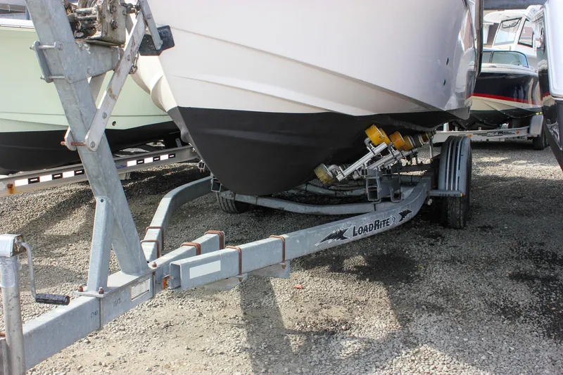 Slide: The Image of 2002 Grady-White Islander 270 boat on Load Rite trailer, parked on gravel. - 11