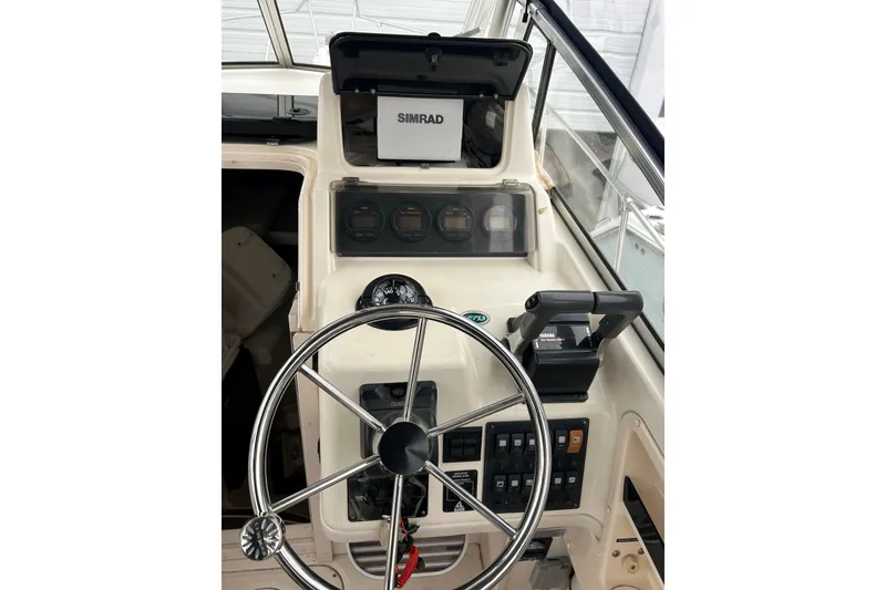 Slide: The Image of Helm of 2002 Grady-White Islander 270 with steering wheel and Simrad electronics. - 6