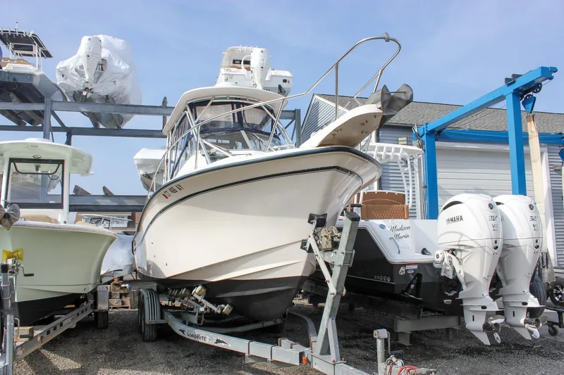 Slide: The Image of 2002 Grady-White Islander 270 boat on trailer, surrounded by other boats in storage. - 9