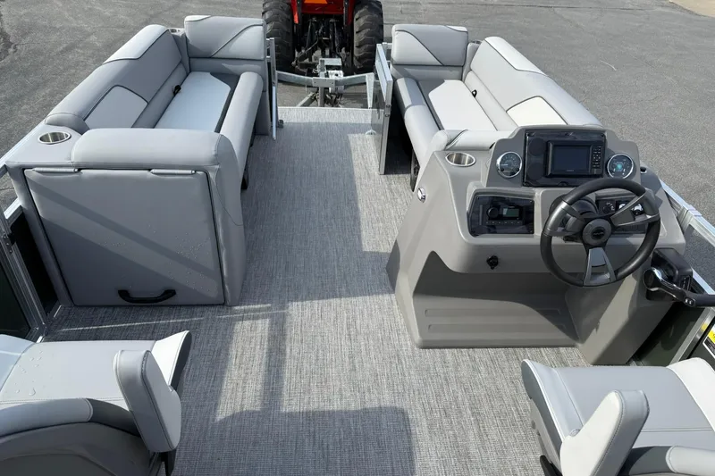 Slide: The Image of 2026 Avalon Venture Quad Lounge 23' pontoon boat interior with modern seating and steering console. - 12