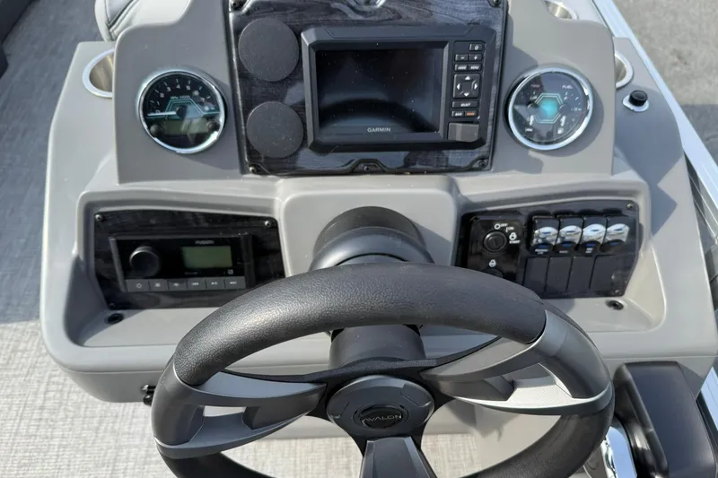 Slide: The Image of Steering console of 2026 Avalon Venture Quad Lounge 23' with modern controls and gauges. - 13