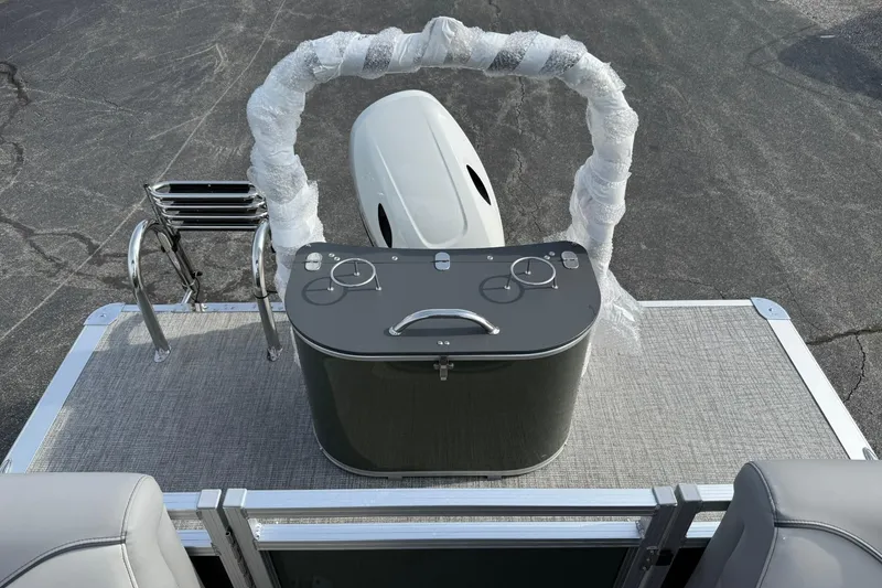 Slide: The Image of 2026 Avalon Venture Quad Lounge boat helm with wrapped steering wheel and ladder. - 17