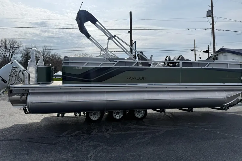 Slide: The Image of 2026 Avalon Venture Quad Lounge 23' pontoon boat on trailer, side view. - 5