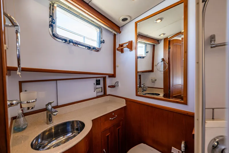Slide: The Image of Luxurious 2006 Grand Banks 47 Europa yacht bathroom with wood accents and modern fixtures. - 14