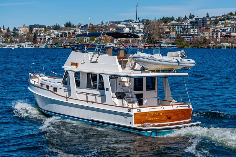 Slide: The Image of 2006 Grand Banks 47 Europa yacht cruising on a scenic waterfront. - 2