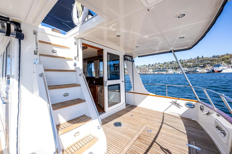 Slide: The Image of 2006 Grand Banks 47 Europa yacht deck with stairs, overlooking scenic waterfront. - 20