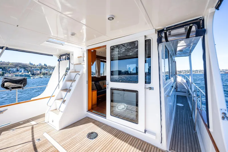 Slide: The Image of 2006 Grand Banks 47 Europa yacht deck with scenic waterfront view. - 21