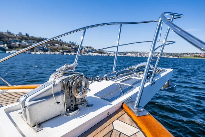 Slide: The Image of Bow of 2006 Grand Banks 47 Europa yacht with anchor winch on a sunny day. - 24