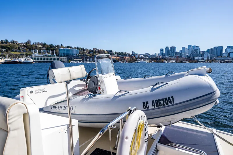 Slide: The Image of Inflatable boat on 2006 Grand Banks 47 Europa yacht, city skyline in background. - 25