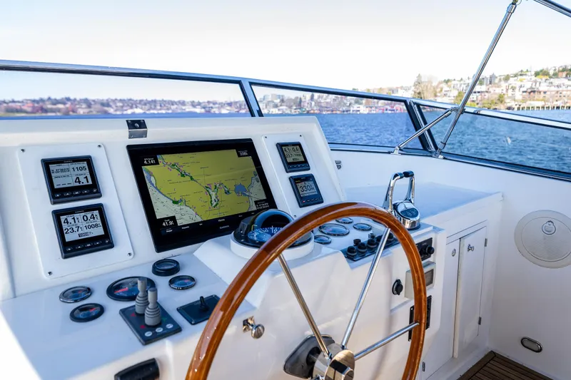 Slide: The Image of Helm of 2006 Grand Banks 47 Europa yacht with navigation instruments and steering wheel. - 28