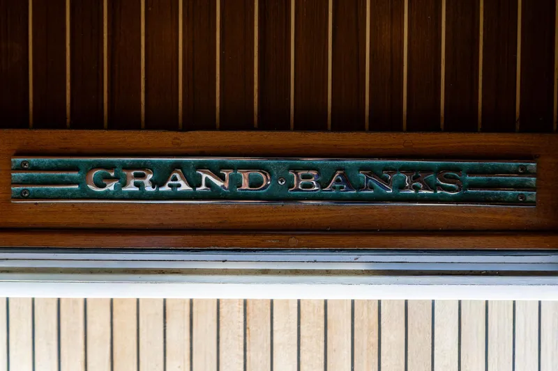 Slide: The Image of Grand Banks 47 Europa 2006 yacht nameplate on wooden paneling. - 31