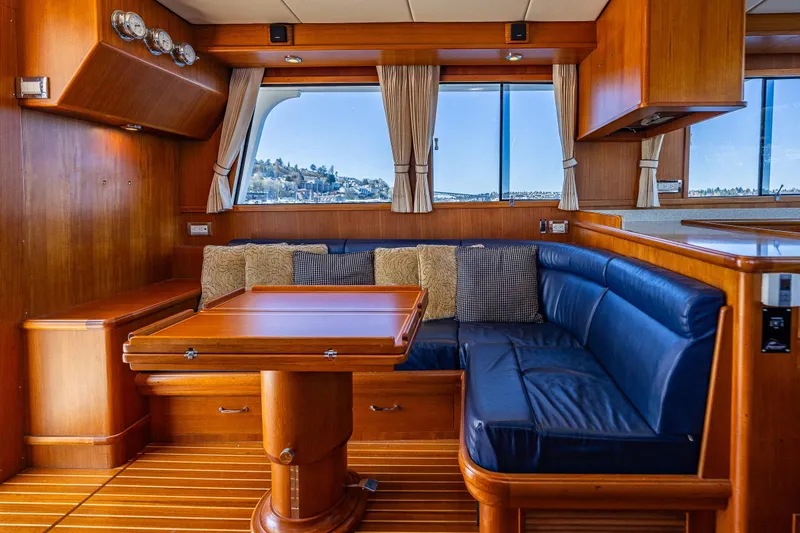 Slide: The Image of Luxurious 2006 Grand Banks 47 Europa yacht interior with wood finish and blue seating. - 36