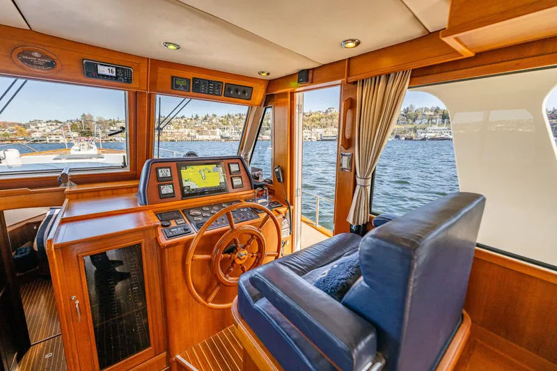 Slide: The Image of Luxurious 2006 Grand Banks 47 Europa yacht interior with navigation equipment and scenic water view. - 37